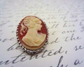 Vintage cameo brooch. Silver toned rope style frame. Carved ivory like material. Pin.