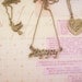 Set of three friendship necklaces. Peace, love, happiness. Brass, gold toned. Dove. Heart with flower. Best friend gift.