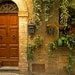 Container gardening in Italy - doorway garden door window flower pots courtyard yellow brick tuscany entranceway - Doorway Garden