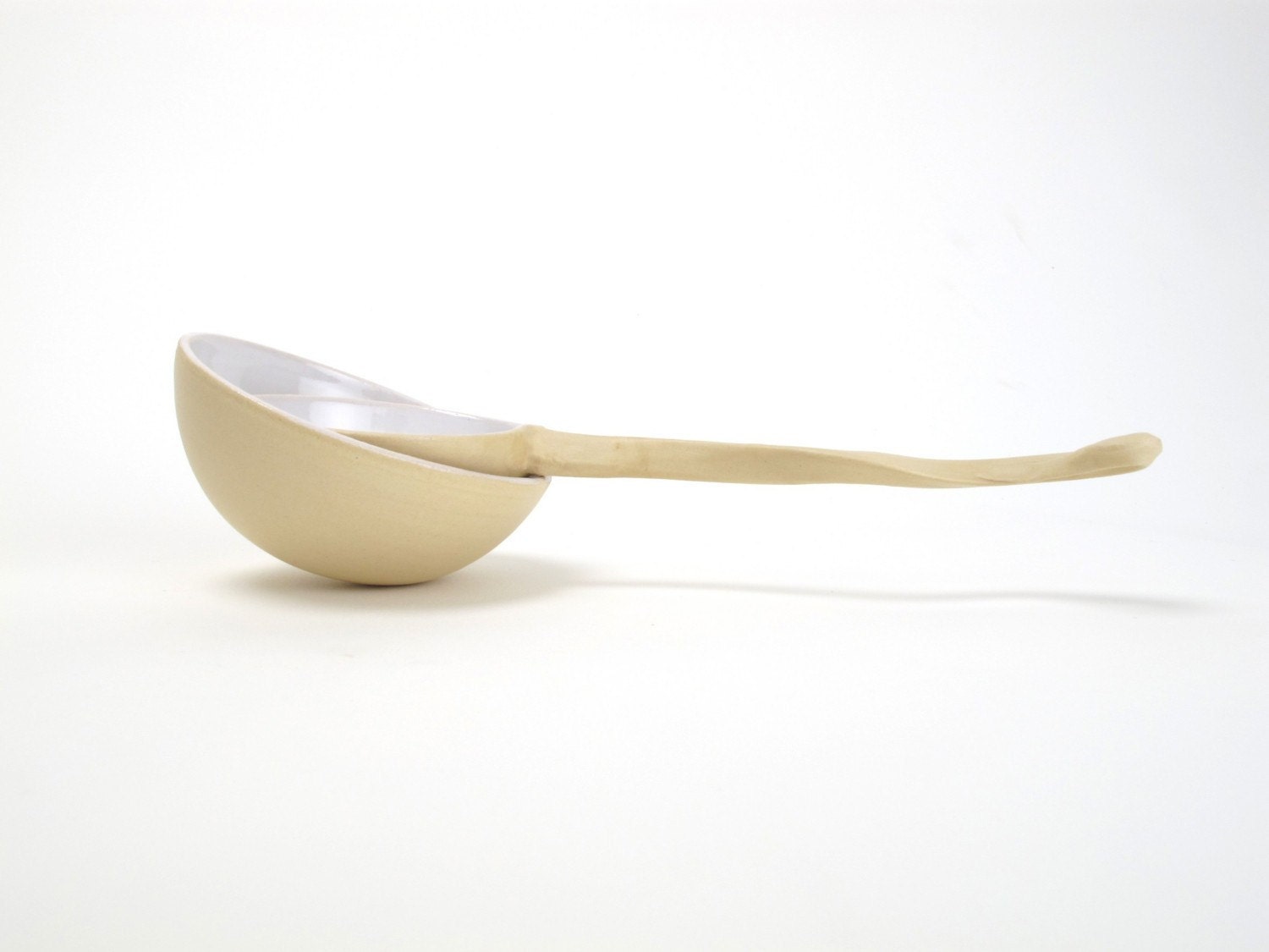 Beautiful tea strainer  with curled grip with a fitting bowl