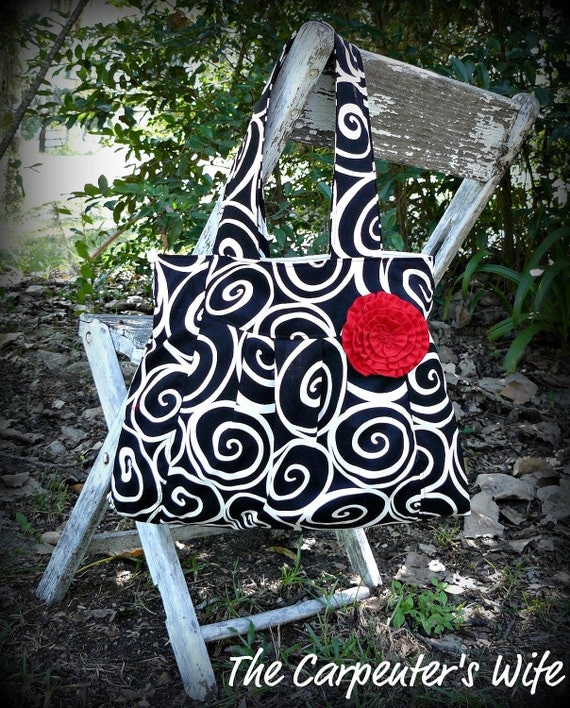 Pleated black and white swirls purse with red rosette