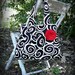 Pleated black and white swirls purse with red rosette
