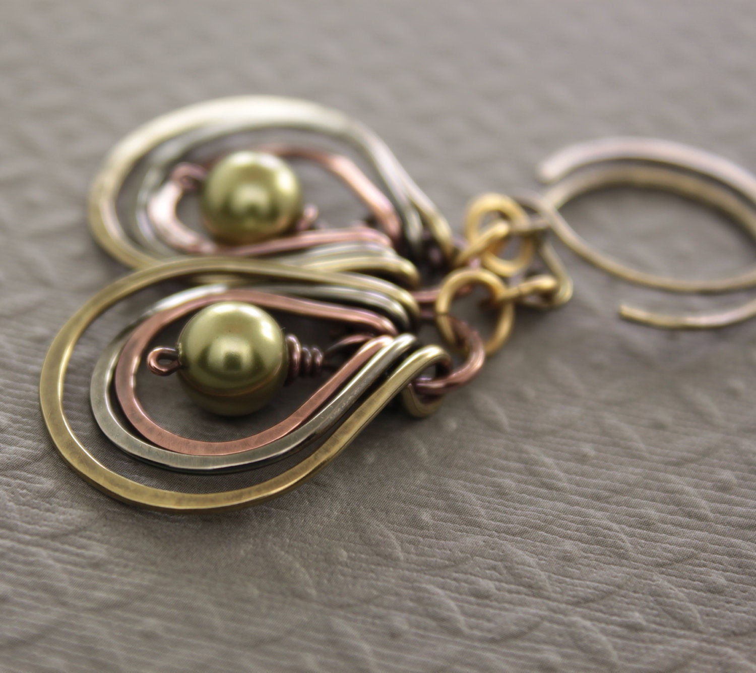 Multicolored metal earrings with copper, German silver and brass hoops with green Swarovski pearls