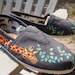 giraffes painted on TOMS shoes