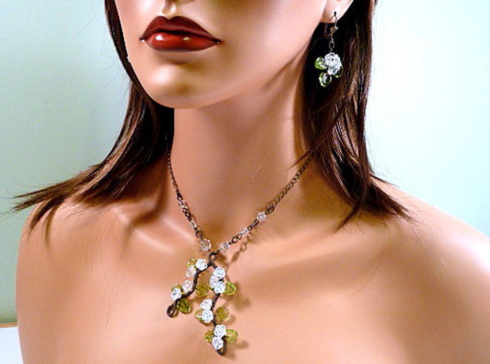 Wire wrapped Necklace and Earrings-floral, crystal clear flowers, green glass leaves, antiqued bronze