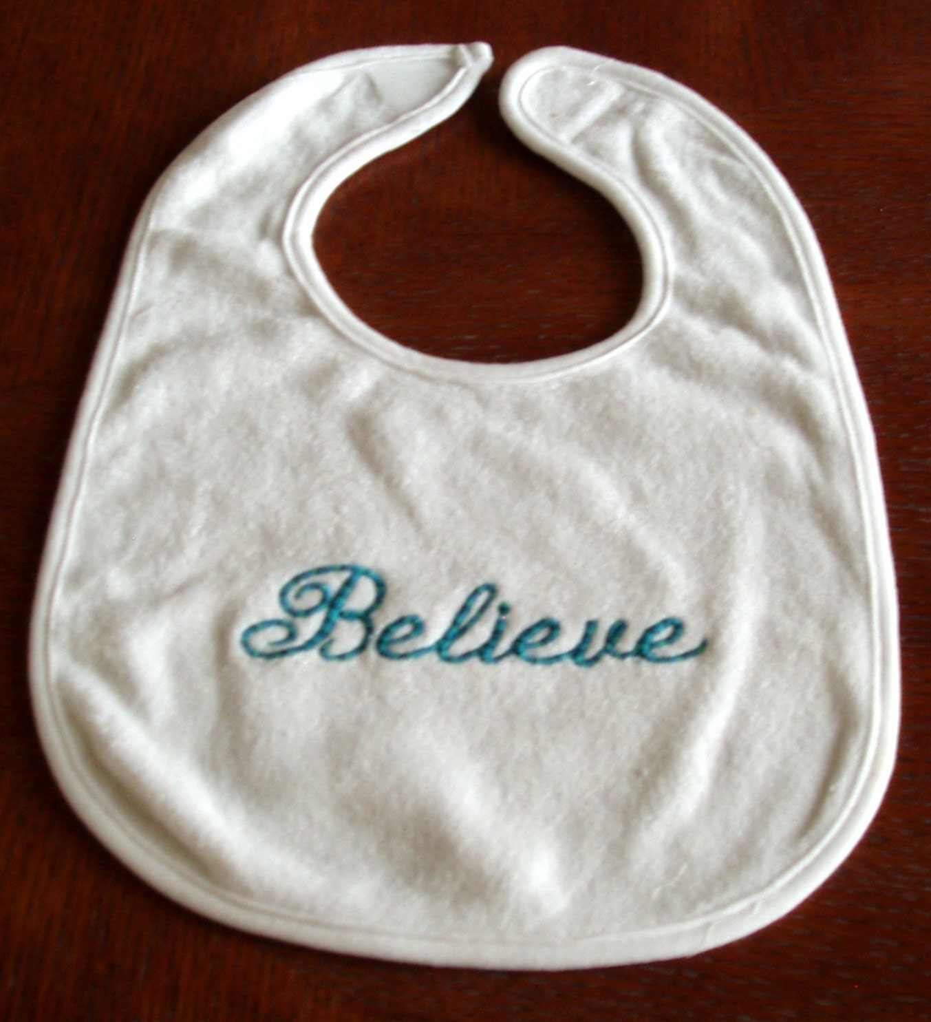 Embroidered baby bib with saying Believe