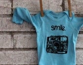 Long Sleeved "Smile" 35 MM camera baby onesie in light turquoise or custom colors