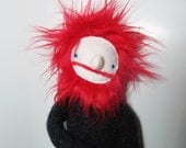 Man fabric doll with black sweater and red hair