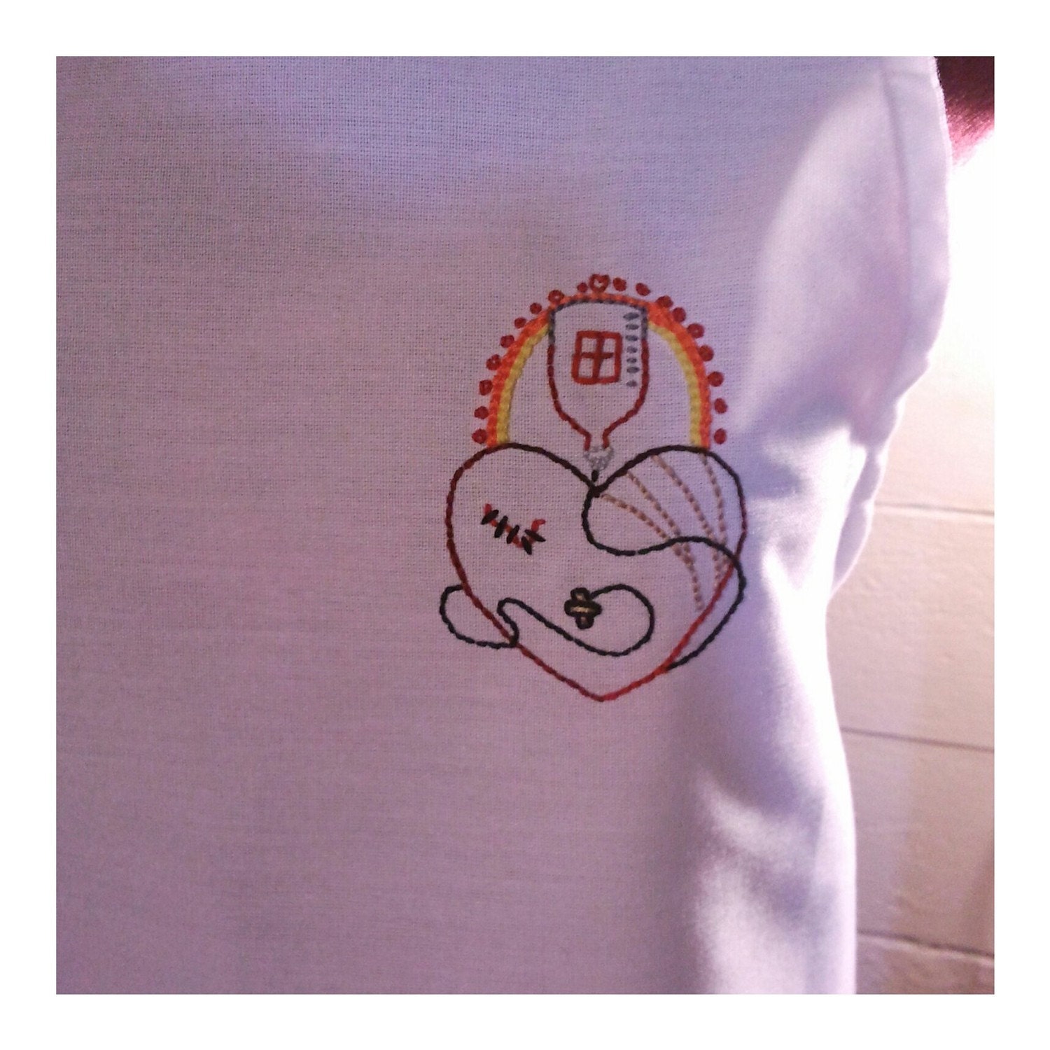 Hand embroidered apron/ mended heart