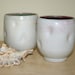 Pair of altered cups in matt white and green