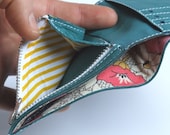 Green leather wallet with space for cards coins and notes