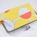Yellow clutch with circles and zigzags