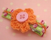a pair of crochet flower clips