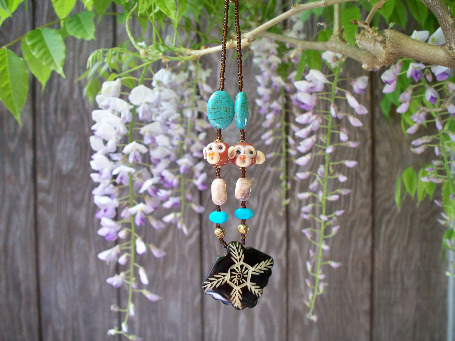 Whimsical Coconut Carved Pendent on a  Hand Strung Monkey Chain