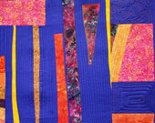 contemporary wall hanging, geometric art quilt in a modern design gold purple and orange