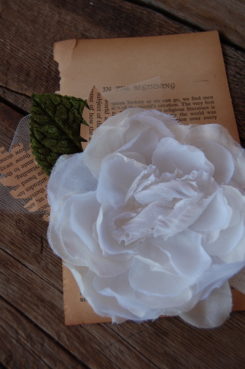 White gardenia with vintage book leaves