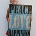 Peace, Love, Happiness. Tin print mounted on wood frame. 16 x 24 inches