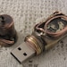 Steampunk USB flash drive with glowing glass windows. 16 GIG. Copper, brass, watch parts and glass. Waterproof.