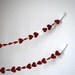 Romantic Paper Hearts Garland - red with a single white heart, 10'