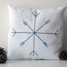 Small white cotton decorative pillow with blue embroidered snowflake