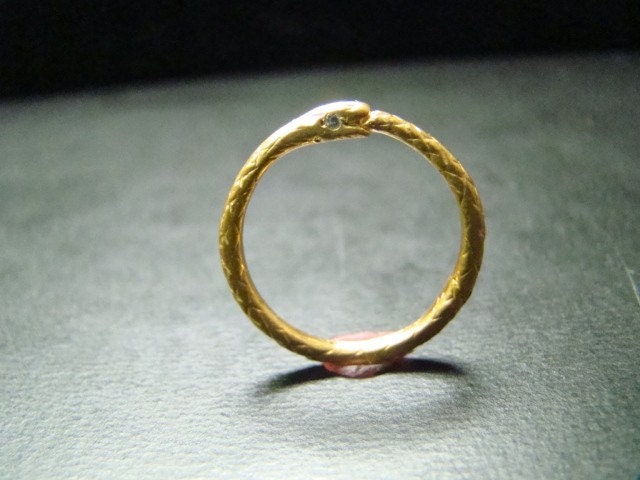14k gold thin snake band with diamond eyes