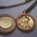 The  Hunger Games real not real hand stamped Peeta's  locket with mockingjay
