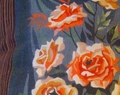 Paint by number fabric cushion. Faux wood and pink and orange flowers.