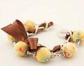 Yellow floral beads and brown ribbon bracelet
