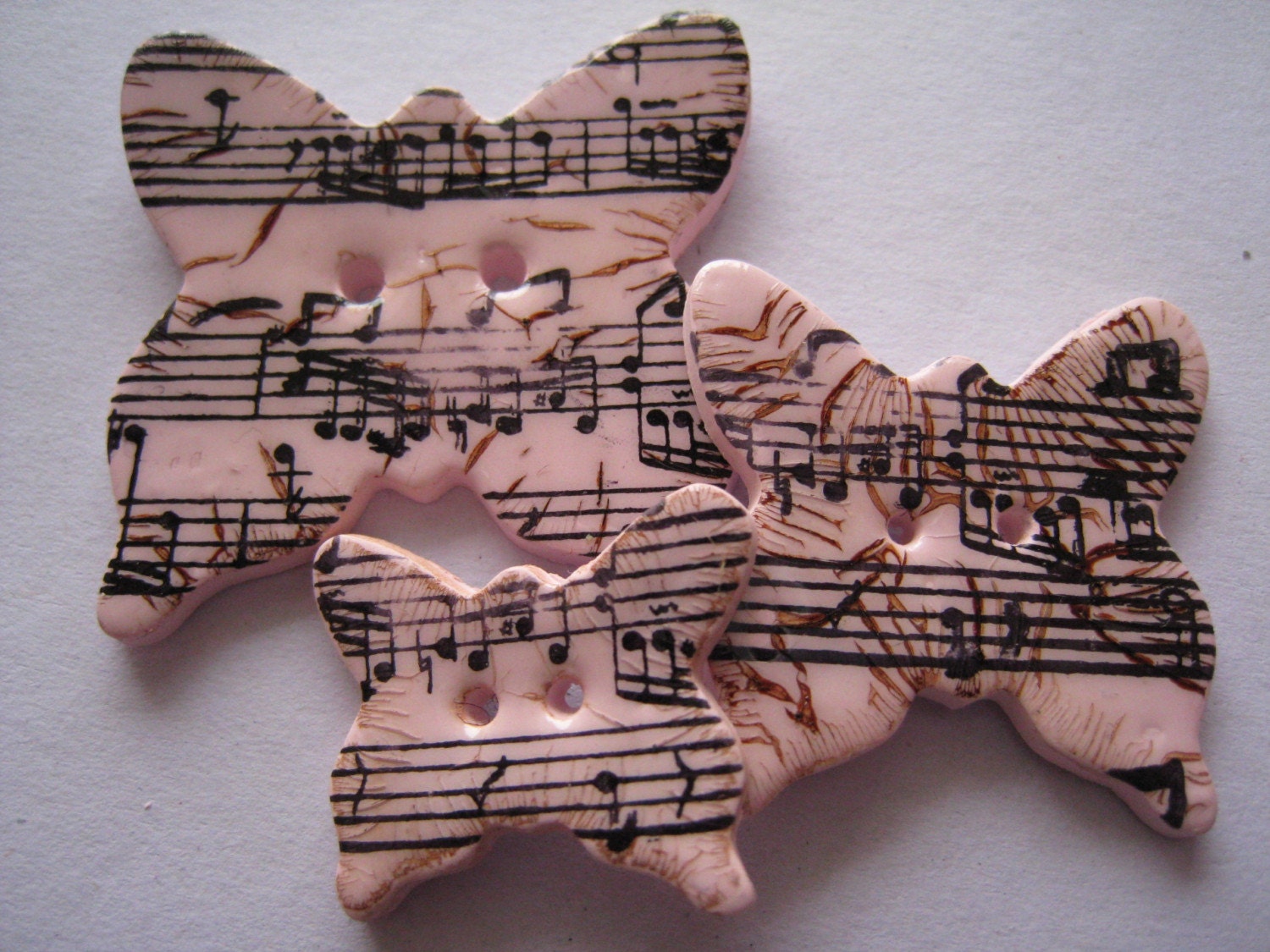Pink polymer clay Butterfly Buttons, distressed sheet music pattern, set of 3