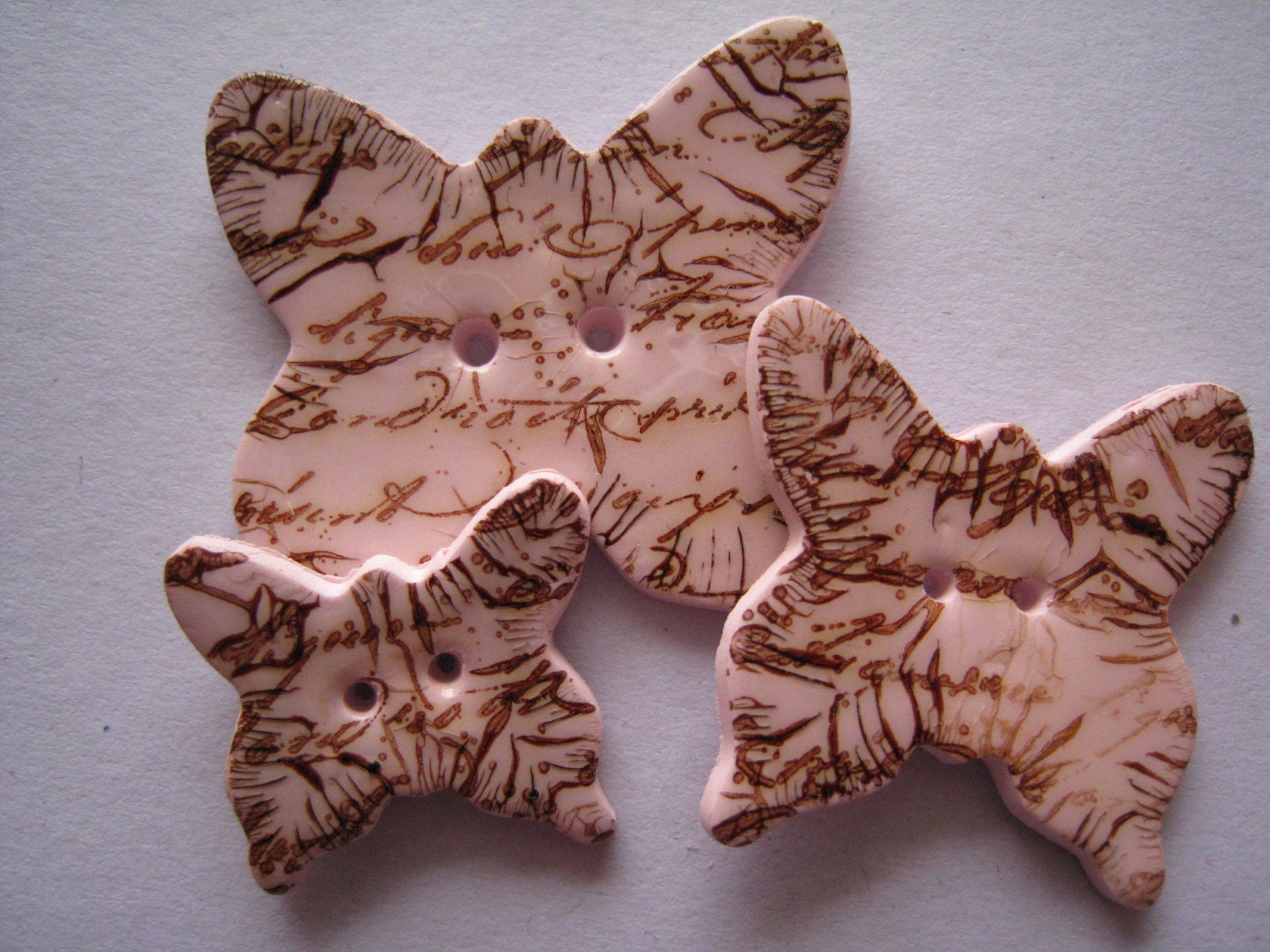 Pink polymer clay Butterfly Buttons, distressed brown script pattern set of 3
