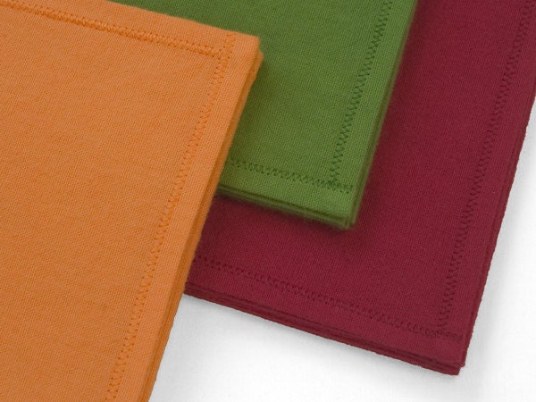 Organic Cotton Hankies in cantaloupe orange, avocado green, and cherry red