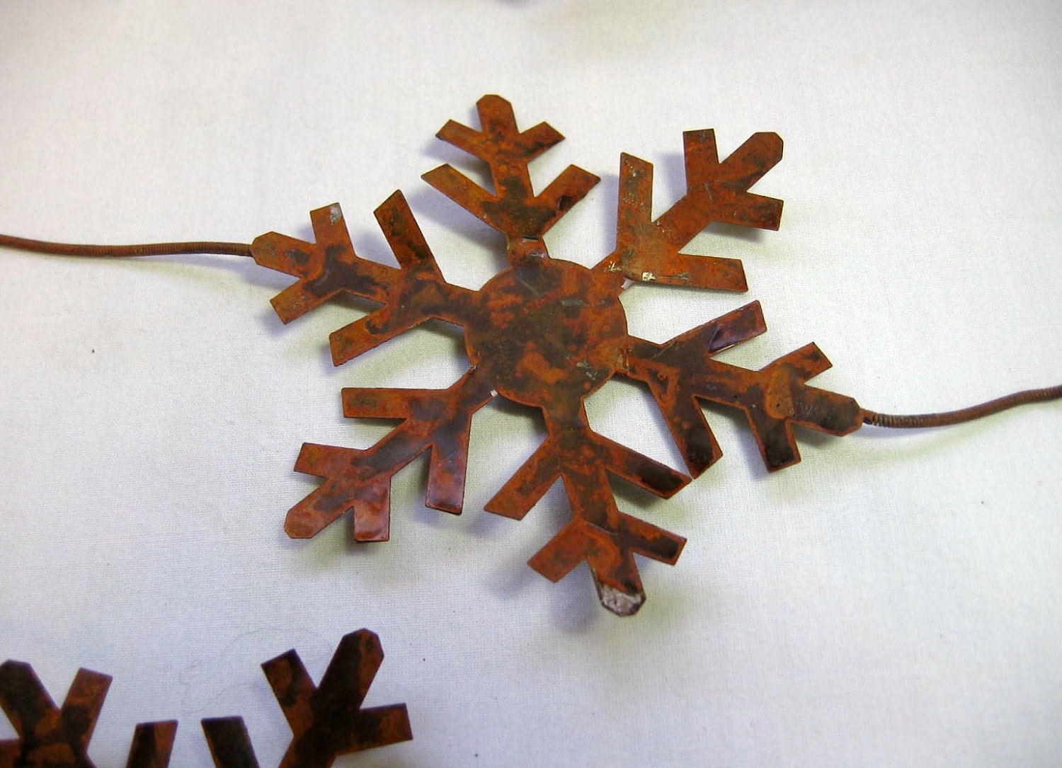 Rusty Tin Snowflake Garland 6 foot long with 3 and 3 quarters inch Snowflakes total of Six Snowflakes