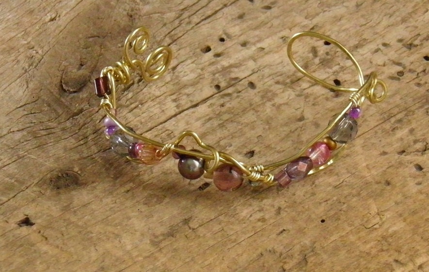 brass wire cuff bracelet with a colorful mix of aubergine beads