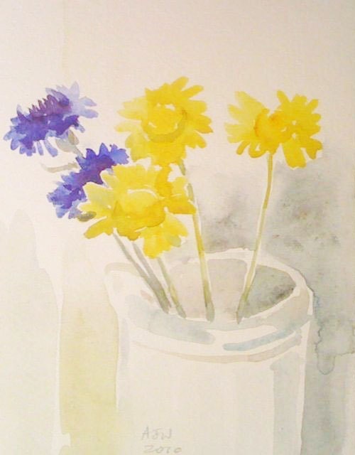 Corn marigold and cornflowers in a stoneware jar