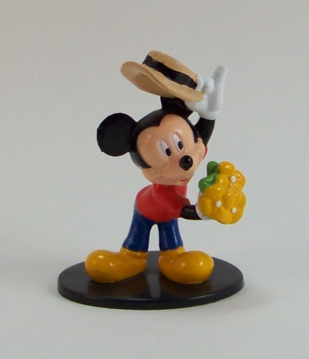 Five Mickey Mouse Collectibles Pez Dispenser, two Keyrings, Tomy car, and a stand up figure