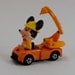 Five Mickey Mouse Collectibles Pez Dispenser, two Keyrings, Tomy car, and a stand up figure