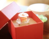A slice of Birthday cake on a cake cover scallop dome  ring