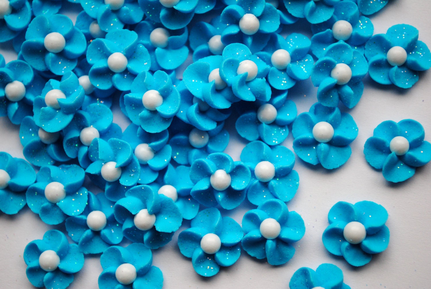 Royal Icing Flowers in Sparkling Sky Blue with White Sugar Pearl Centers (100)