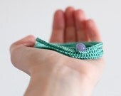 Crochet Bracelet . Pastel green with lilac button .