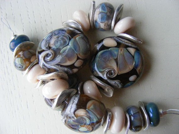 set of handmade beads with soft peach and silvered glass