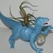 Dinosaur planter. Dylan the Deinonychus in pearl blue with air plant and custom bottle cap.