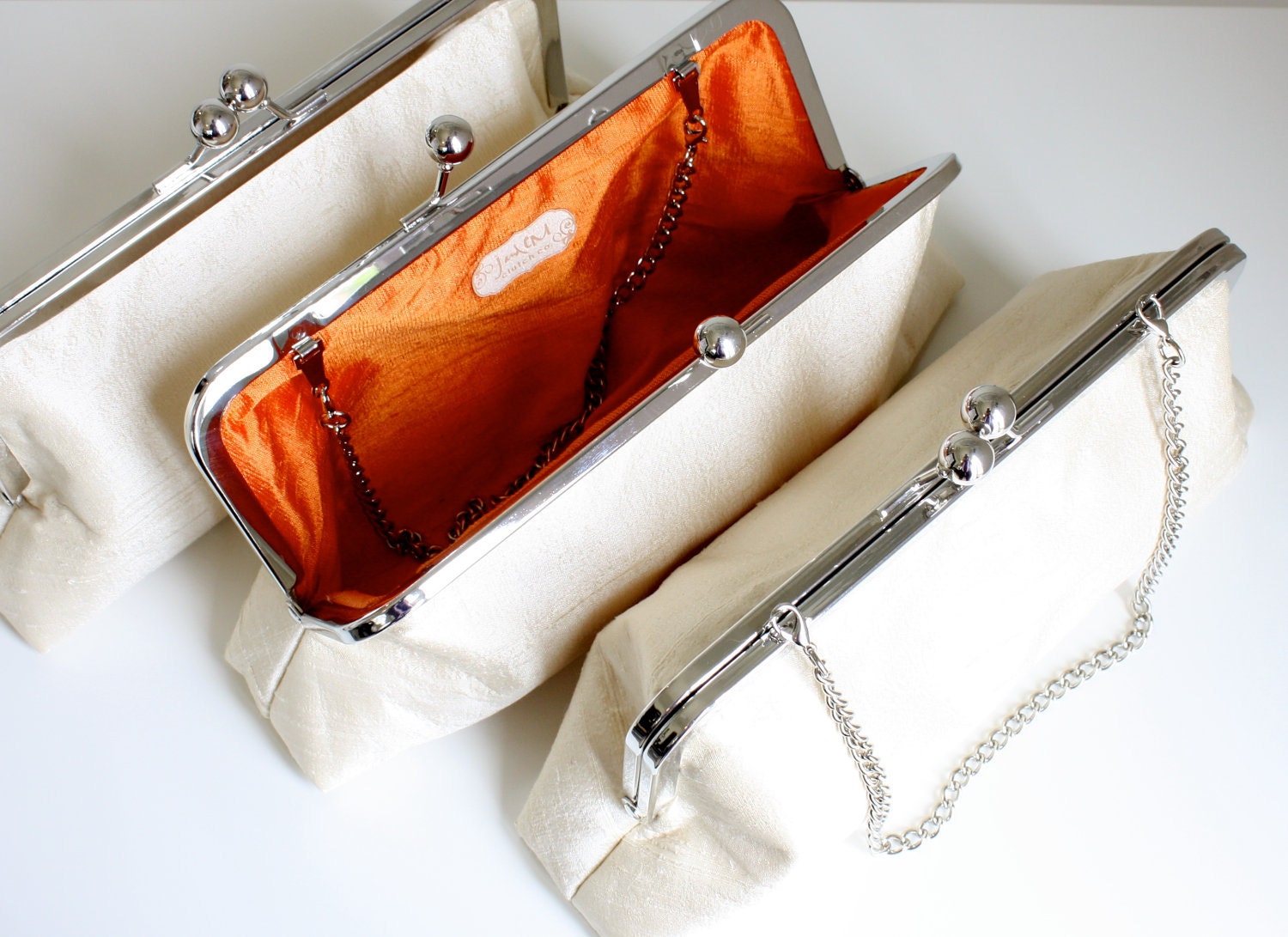 Antique White Wedding Clutches with Clementine Orange Silk Lining can be customized to your wedding palette