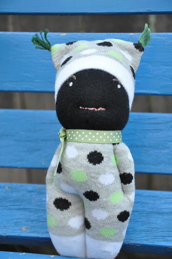 Black sock doll in green, black and white polka dots