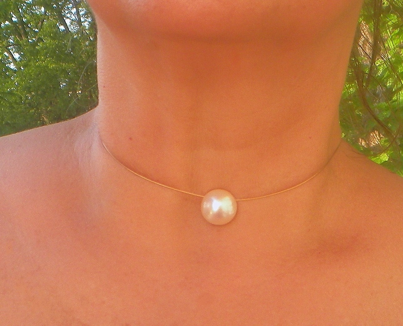 elegant and simple mabe' pearl floating on smooth 24k GP cord