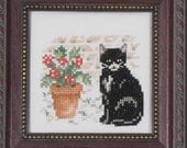 Black Kitty Cat With A Pot of Flowers - A Framed Picture