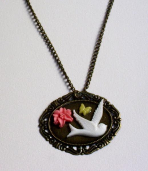 White bird, flower, and butterfly cabochon panel necklace.