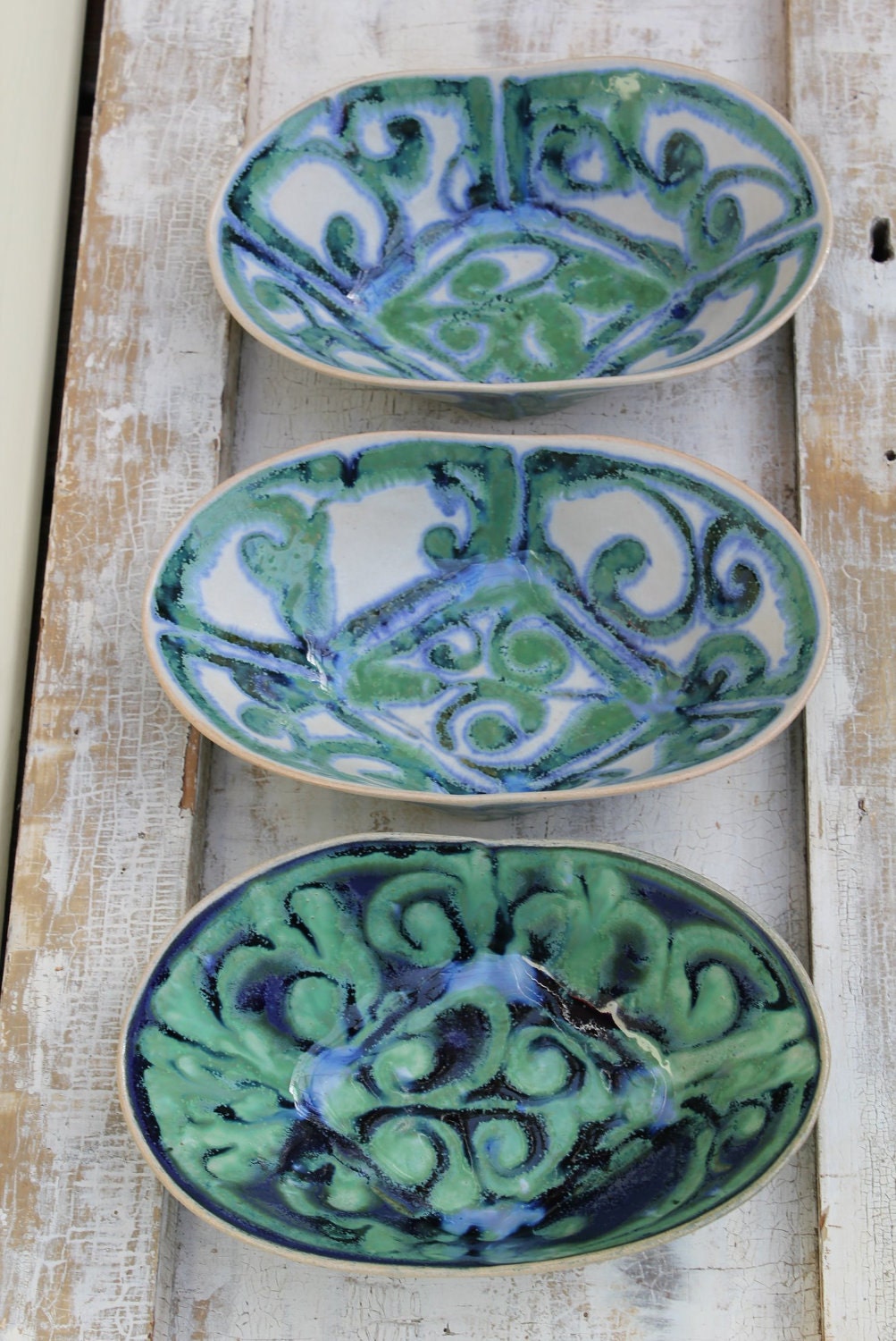 folded oval bowls in greens, blues and cream