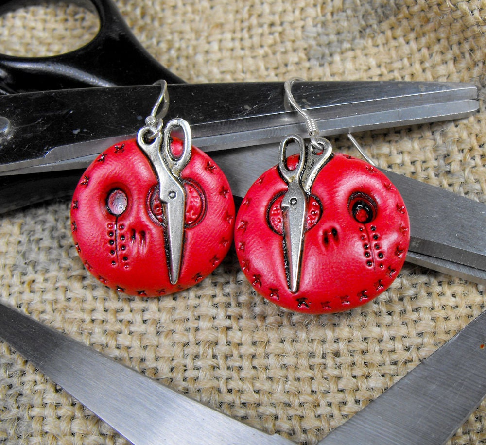 Super cool mini red skull earrings with a metal scissors in his eye. Sterling silver hooks. Creepy and cute at the same time