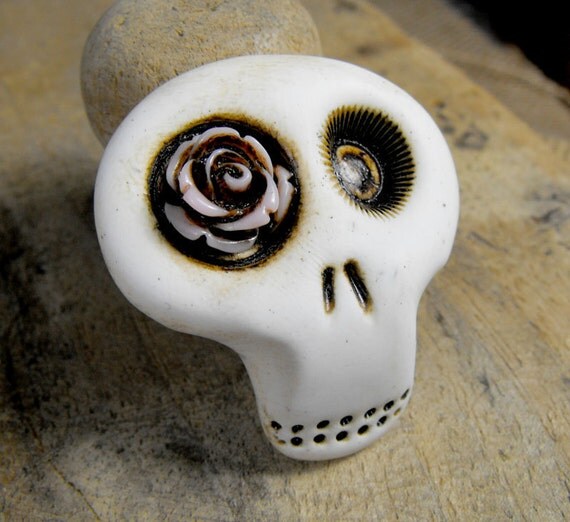 Mini sugar skull brooch with a lovely light pink rose his eye. A little bit dirty flower from any creepy cementery. Ha, ha, ha...