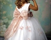 Pick your color flower girl dress with a pink sash and flowers. A silk dress for a wedding ceremony. Junior bridesmaid dresses